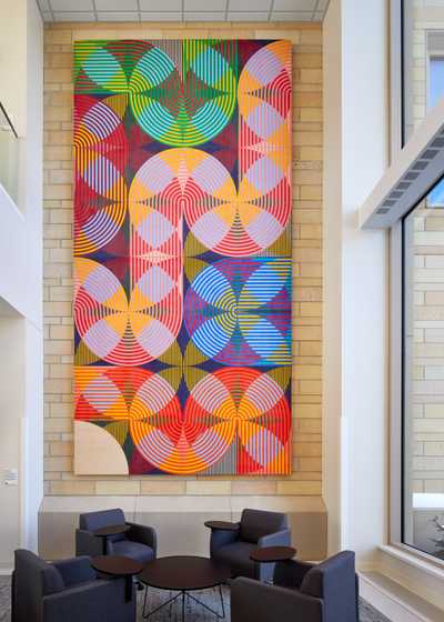 Geometrical art hanging on a wall from downstairs