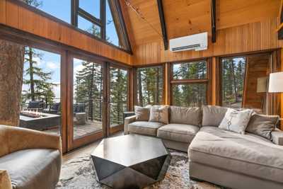 Lounge room with couches and lots of windows