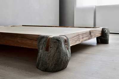 Sculptural bed frame made of wood and stone