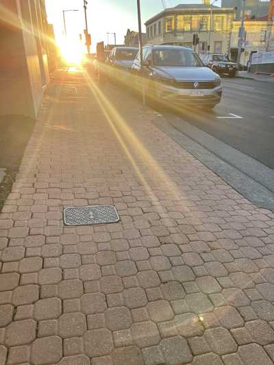 Photo of a footpath with a bright sun in the sky