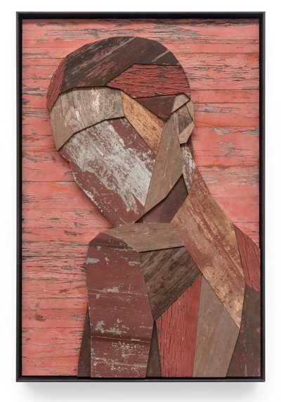 Wooden sculpture of a man looking over his shoulder