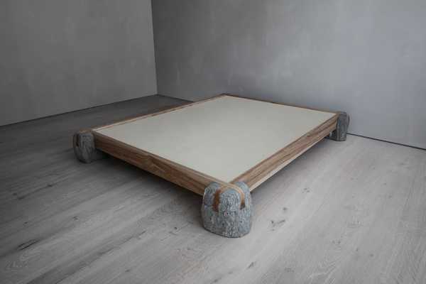 Sculptural bed frame made of wood and stone