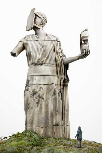 Sculpture of a woman with a phone taped to her face