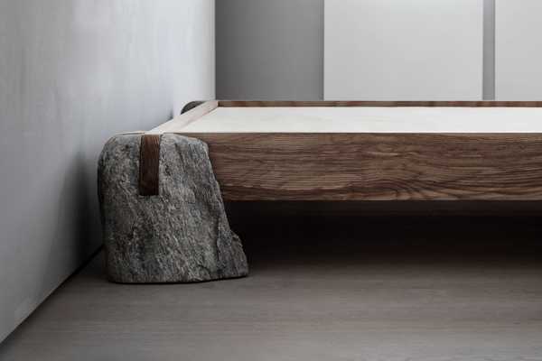 Sculptural bed frame made of wood and stone