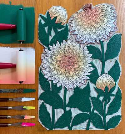 Flatlay of a floral vinyl carving and the paint applied
