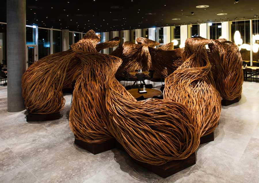 Photo of a weaved wooden sculpture inside an office building