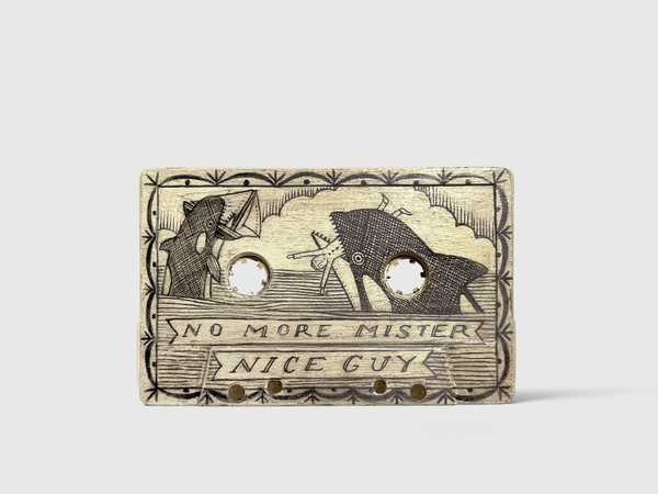 Scrimshaw in the shape of a cassette, with a drawing of 2 whales attacking a boat with No More Mister Nice Guy in text