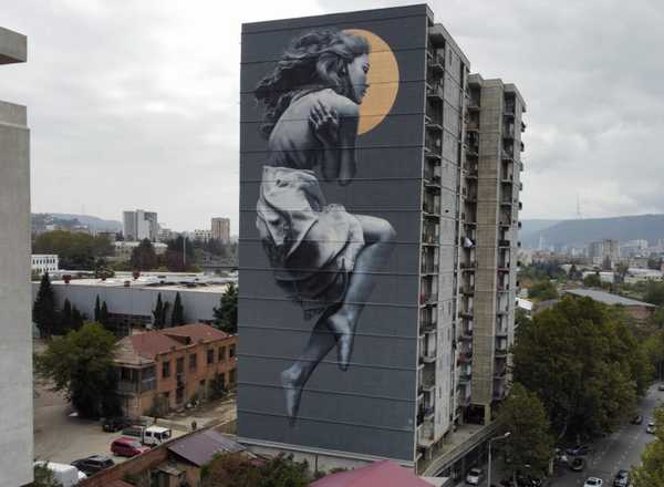 Mural of a woman on the side of a building