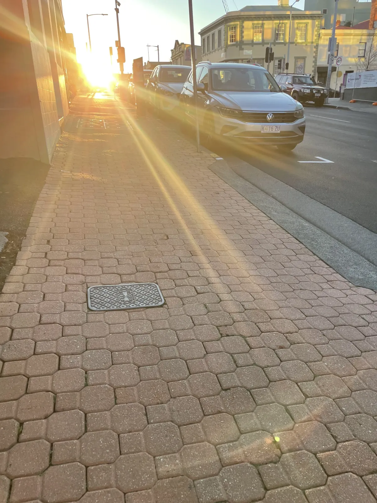 Photo of a footpath with a bright sun in the sky