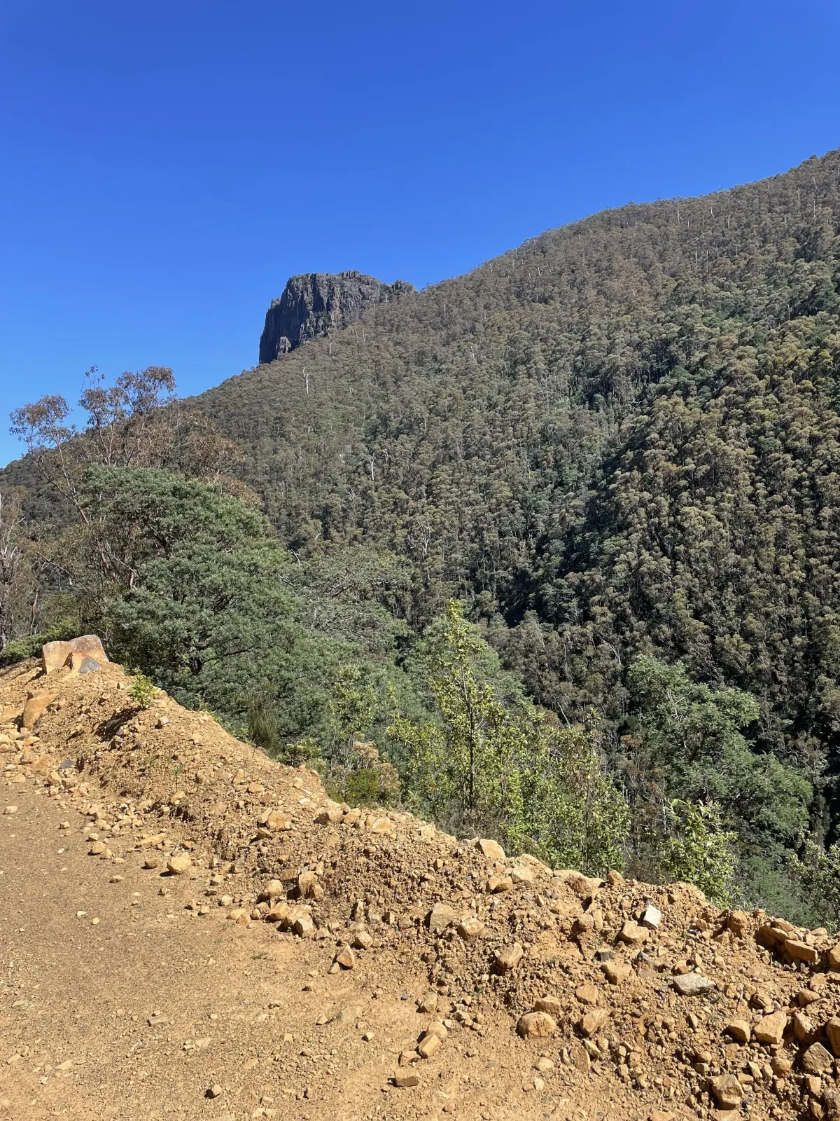 Looking at a hill from a rock trail