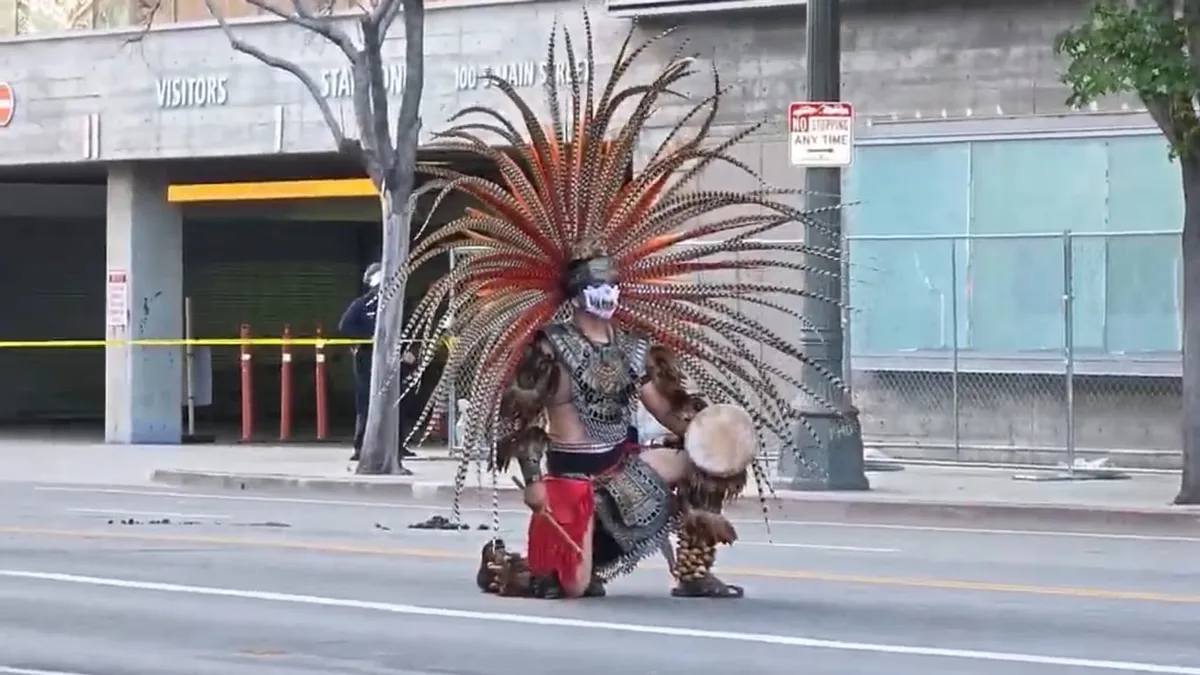 Man kneeling in native amierican dress