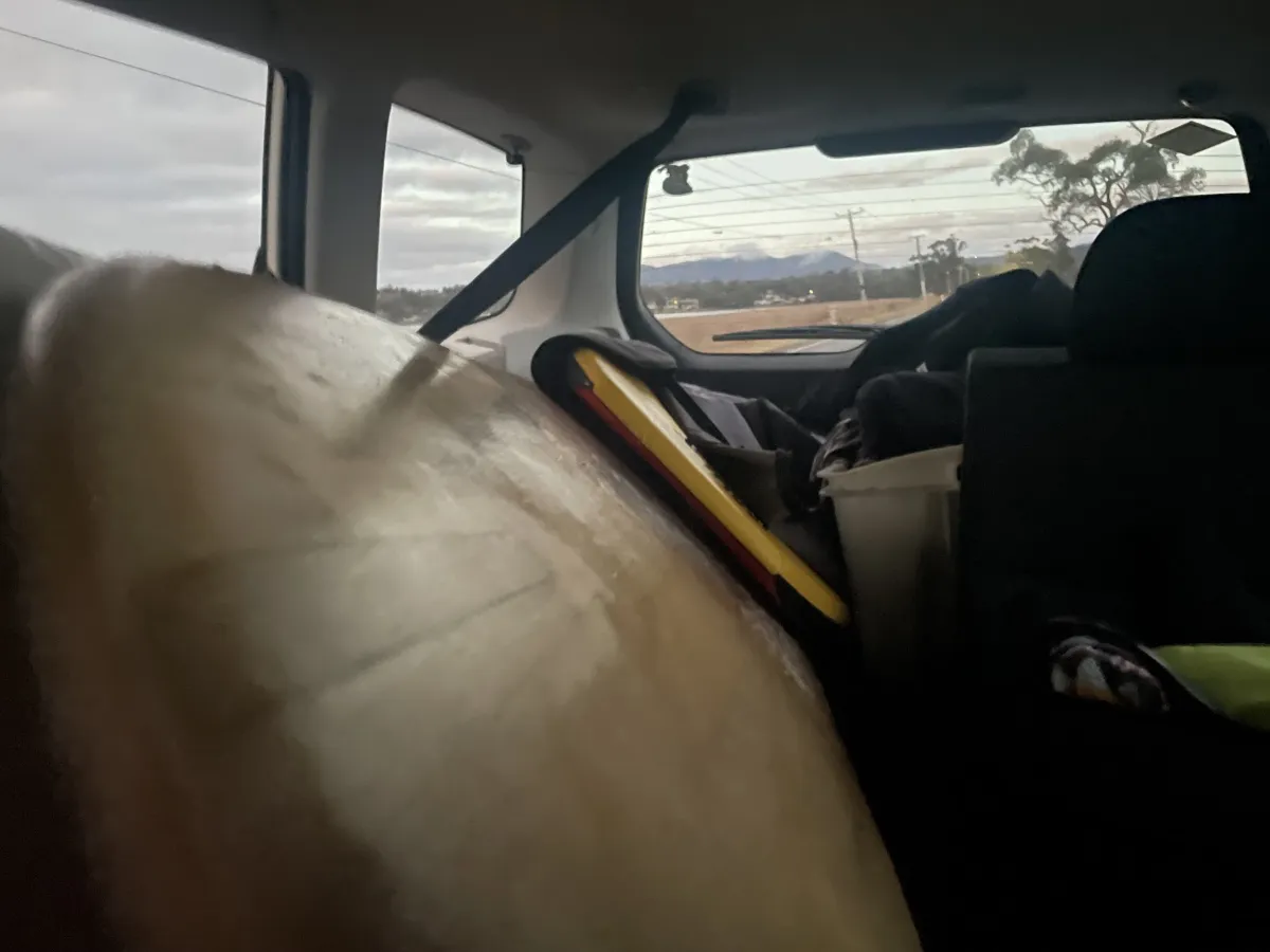 Surf board in the back of a car