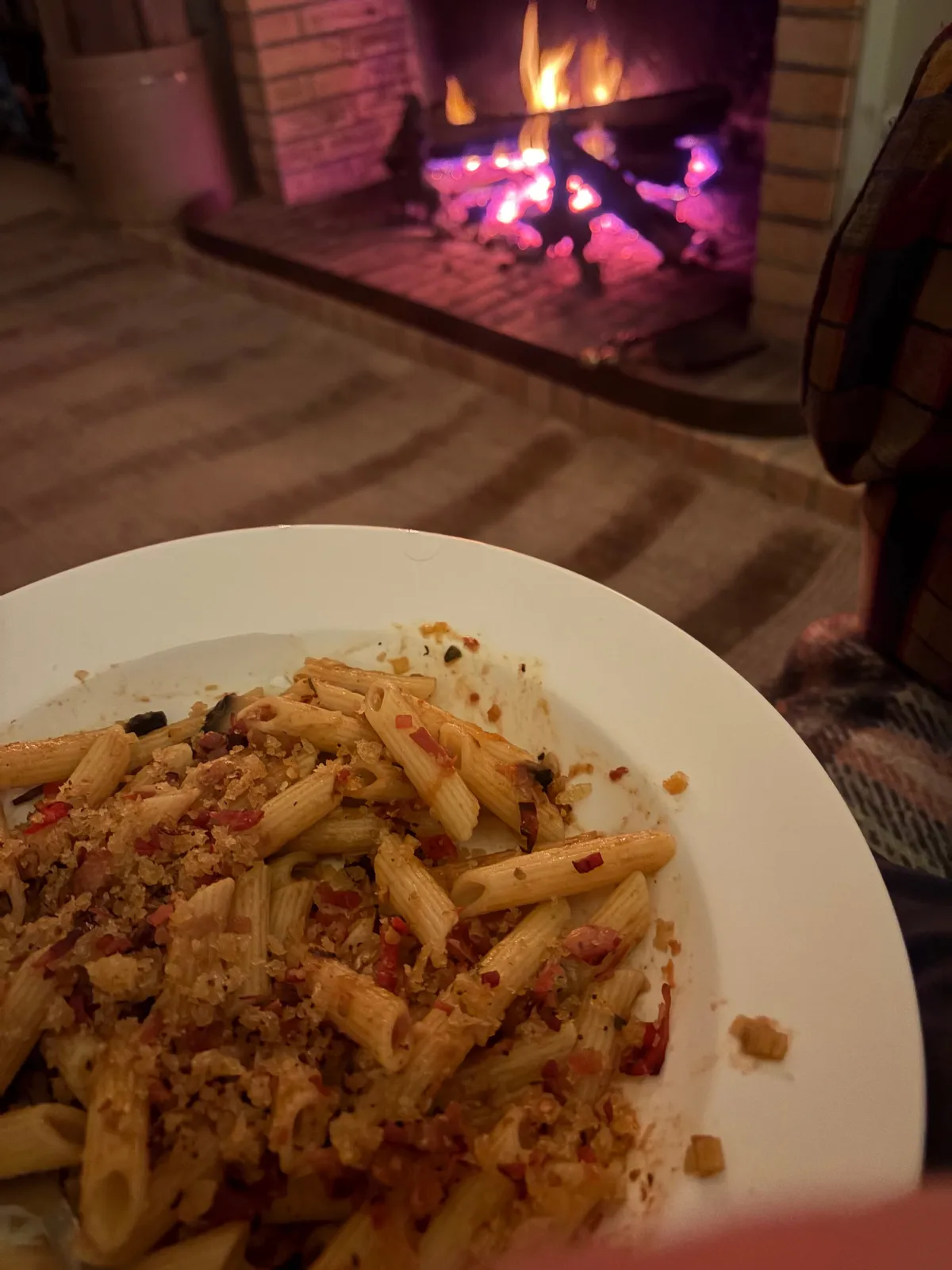 Pasta next to a fireplace
